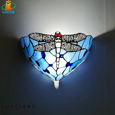 Elegant handmade dragonfly glass wall sconce.